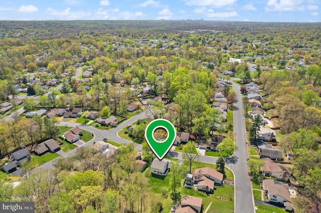 aerial view featuring a forest view and a residential view