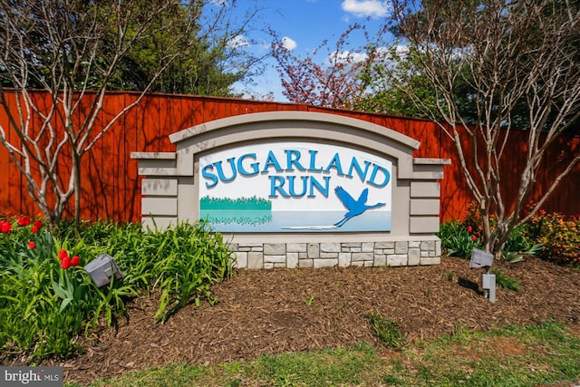 community sign featuring fence