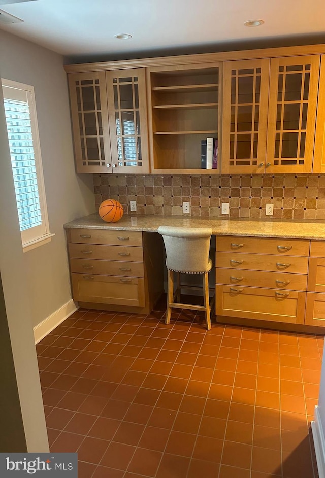 42 Rebecca Ct, Ewing, NJ 08628 - kitchen featuring glass insert cabinets, built in desk, dark tile patterned flooring, and tasteful backsplash