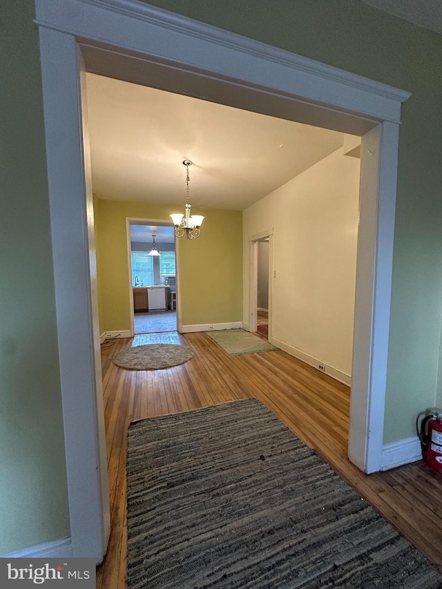 2261 Sidney Ave, Baltimore, MD 21230 - interior space featuring baseboards, wood finished floors, and a notable chandelier