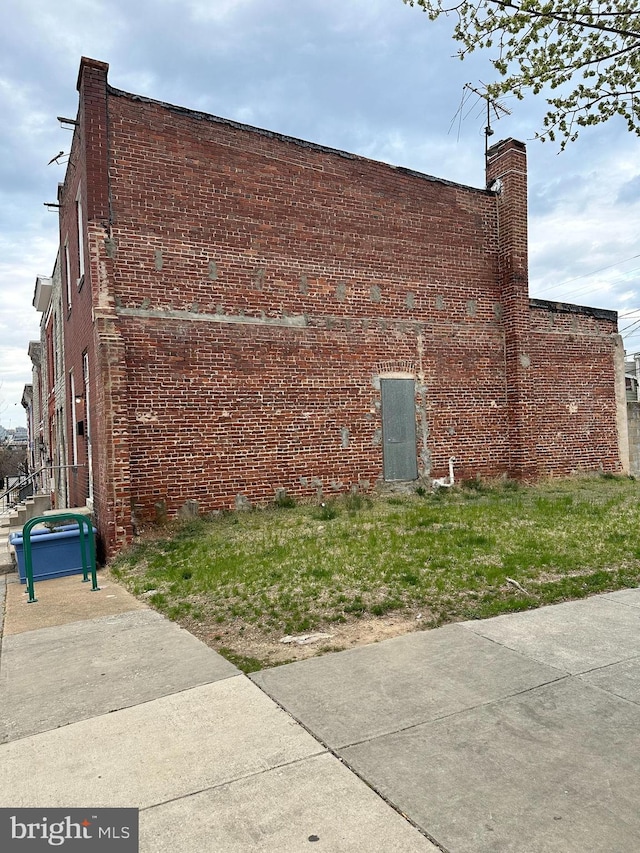 2261 Sidney Ave, Baltimore, MD 21230 - view of property exterior with a chimney and brick siding