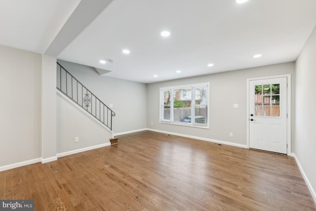 2918 Landover St, Alexandria, VA 22305 - unfurnished living room featuring stairway, plenty of natural light, baseboards, and wood finished floors