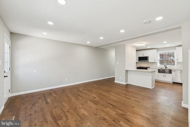 2918 Landover St, Alexandria, VA 22305 - unfurnished living room with recessed lighting, baseboards, dark wood-style flooring, and a sink