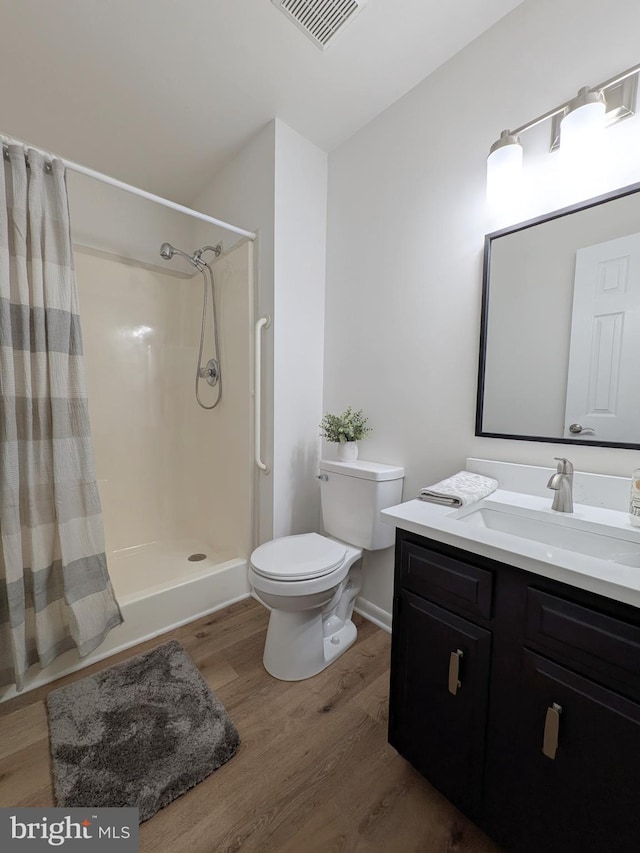 1505 Cedarcrest Ln, Frederick, MD 21702 - bathroom featuring wood finished floors, toilet, vanity, and a shower with shower curtain