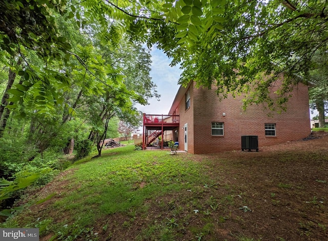 1505 Cedarcrest Ln, Frederick, MD 21702 - view of side of property featuring brick siding, a wooden deck, central AC unit, a lawn, and stairs