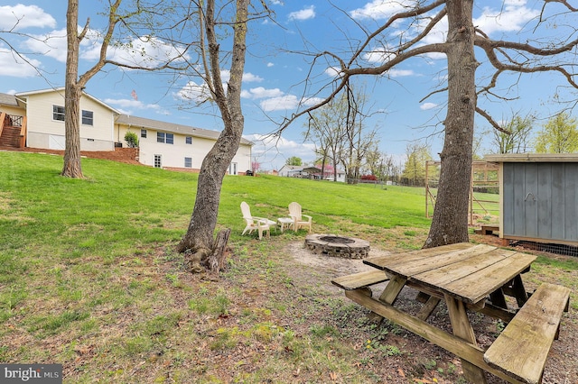 view of yard with a fire pit