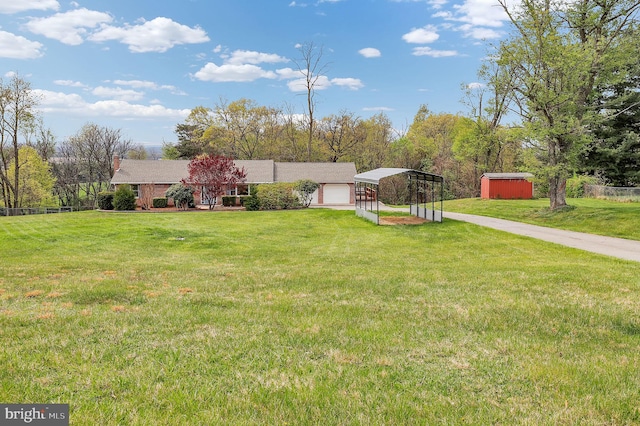 view of front of property featuring a detached carport, a front lawn, and driveway