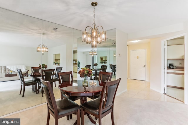 dining room with baseboards, light carpet, a notable chandelier, and light tile patterned flooring