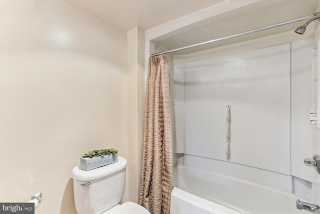 full bath with shower / bath combo with shower curtain and toilet