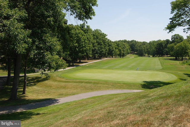 view of home's community with a yard and golf course view