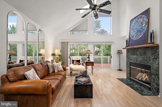 1506 N Bay Shore Dr, Milton, DE 19968 - living room with baseboards, a ceiling fan, hardwood / wood-style floors, high vaulted ceiling, and a tile fireplace