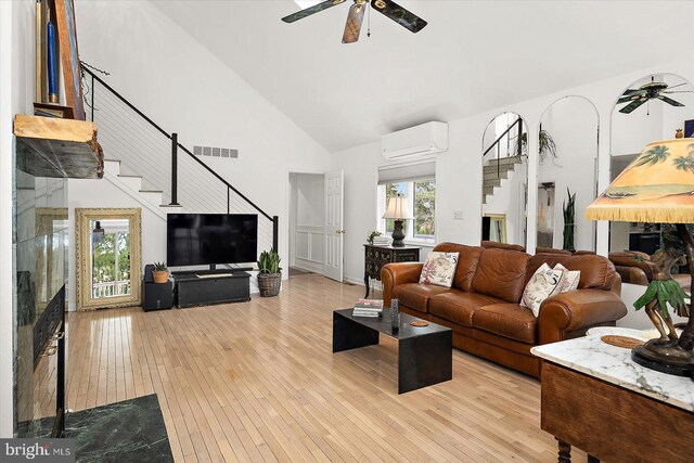 1506 N Bay Shore Dr, Milton, DE 19968 - living room with stairs, visible vents, a ceiling fan, and a wall unit AC