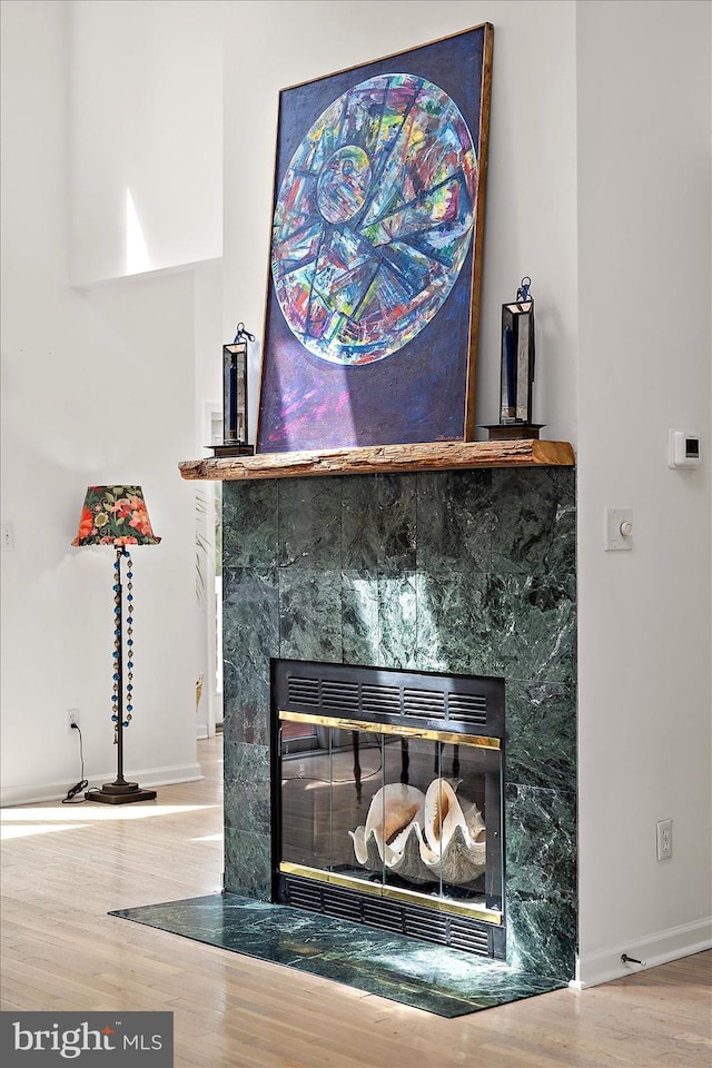 1506 N Bay Shore Dr, Milton, DE 19968 - room details featuring wood finished floors, a tiled fireplace, and baseboards