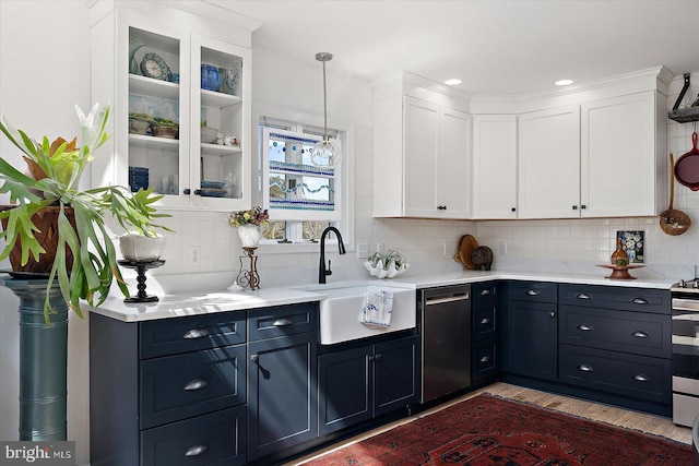 1506 N Bay Shore Dr, Milton, DE 19968 - kitchen featuring tasteful backsplash, a sink, light countertops, appliances with stainless steel finishes, and white cabinetry