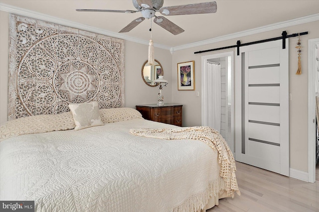 1506 N Bay Shore Dr, Milton, DE 19968 - bedroom with ornamental molding, ceiling fan, a barn door, and light wood-style floors