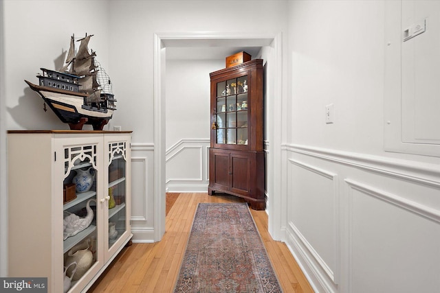 1506 N Bay Shore Dr, Milton, DE 19968 - doorway to outside featuring a decorative wall, a wainscoted wall, and light wood-style floors