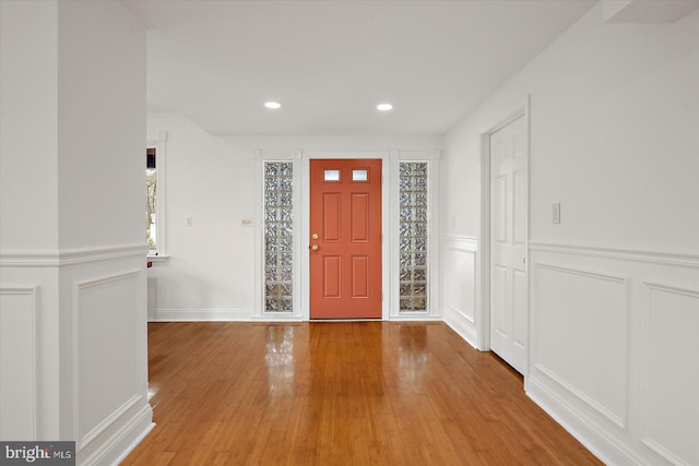 1506 N Bay Shore Dr, Milton, DE 19968 - foyer entrance featuring a decorative wall, light wood finished floors, a wainscoted wall, and recessed lighting