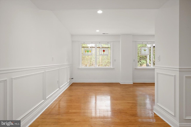 1506 N Bay Shore Dr, Milton, DE 19968 - unfurnished dining area with a decorative wall, light wood finished floors, wainscoting, and recessed lighting