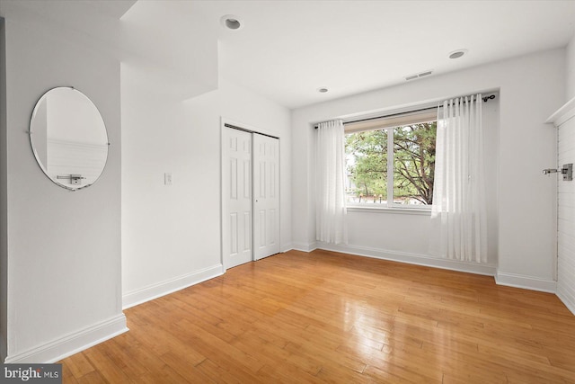 1506 N Bay Shore Dr, Milton, DE 19968 - unfurnished bedroom with light wood-style floors, visible vents, baseboards, and a closet