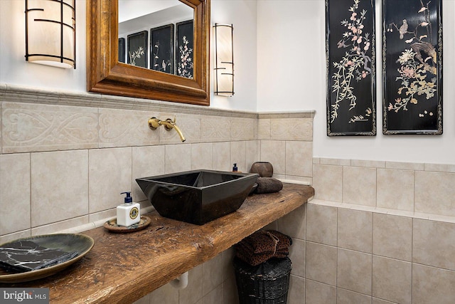 1506 N Bay Shore Dr, Milton, DE 19968 - bathroom featuring a sink, wainscoting, and tile walls