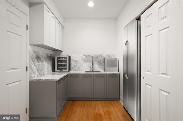 1506 N Bay Shore Dr, Milton, DE 19968 - kitchen featuring stainless steel refrigerator, gray cabinets, a sink, light countertops, and beverage cooler