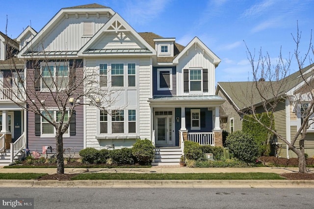 105 Arch St, Milton, DE 19968 - view of front of home with board and batten siding, a standing seam roof, covered porch, and metal roof