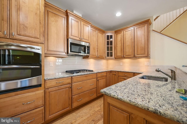 105 Arch St, Milton, DE 19968 - kitchen featuring tasteful backsplash, light stone counters, a sink, and stainless steel appliances