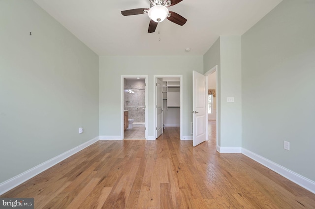 105 Arch St, Milton, DE 19968 - unfurnished bedroom featuring a spacious closet, light wood-style floors, baseboards, and a closet