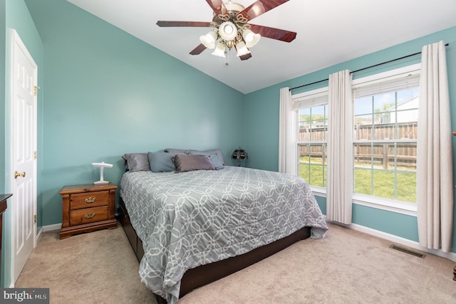 bedroom with carpet floors, baseboards, vaulted ceiling, and visible vents