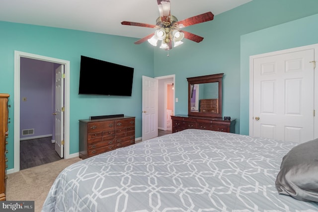 carpeted bedroom featuring visible vents, baseboards, and ceiling fan