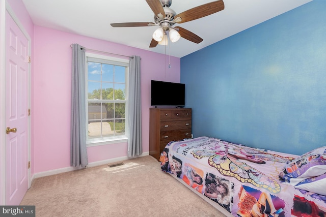bedroom with visible vents, carpet flooring, baseboards, and a ceiling fan