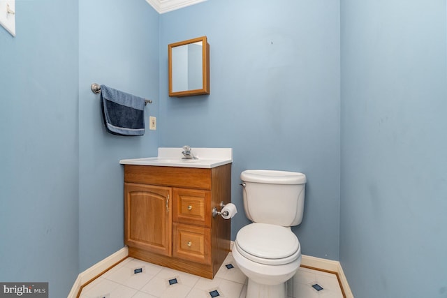 bathroom with baseboards, tile patterned flooring, vanity, and toilet