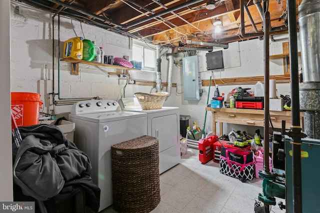 laundry room featuring electric panel, tile patterned floors, independent washer and dryer, and laundry area