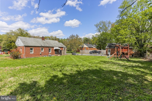 view of yard featuring a fenced backyard and a playground