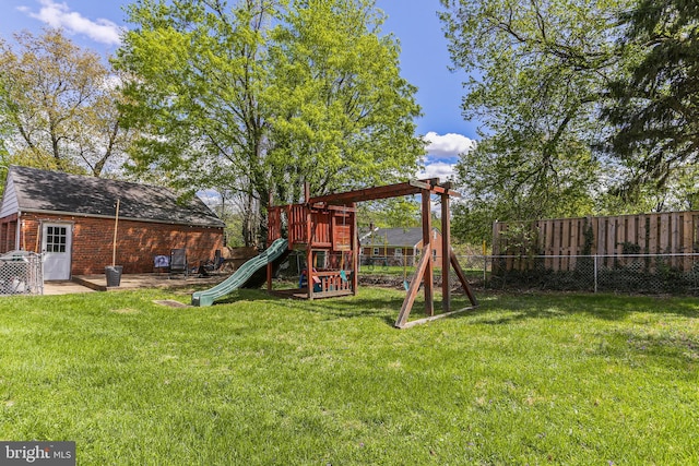view of playground featuring fence and a yard