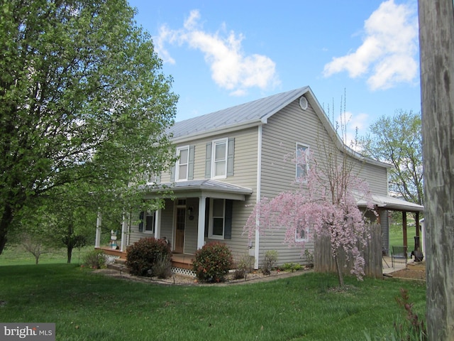1671 Fravel Rd, Woodstock, VA 22664 - view of side of home with covered porch, metal roof, and a yard