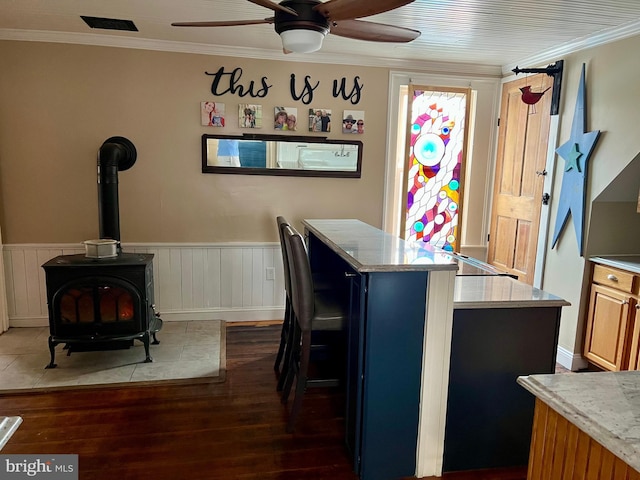 1671 Fravel Rd, Woodstock, VA 22664 - kitchen with dark wood-style floors, ceiling fan, crown molding, a center island, and a wood stove