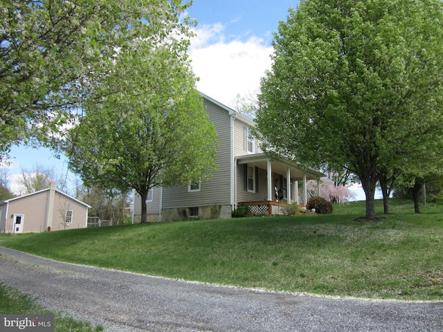 1671 Fravel Rd, Woodstock, VA 22664 - view of property exterior with a porch and a yard