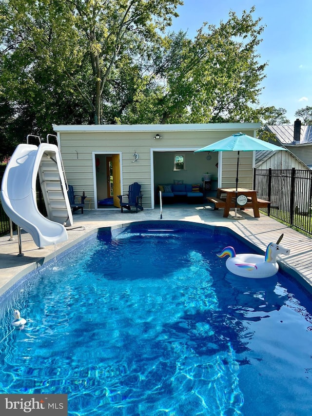 1671 Fravel Rd, Woodstock, VA 22664 - view of swimming pool featuring a water slide, fence, a patio, and an outdoor living space