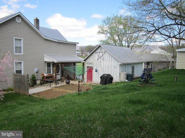 1671 Fravel Rd, Woodstock, VA 22664 - rear view of property with a lawn, a patio area, a chimney, and an outbuilding