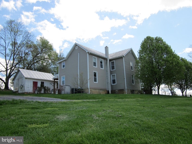 1671 Fravel Rd, Woodstock, VA 22664 - view of side of home featuring a lawn, metal roof, a chimney, and central AC unit