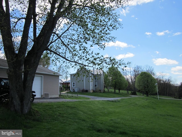 1671 Fravel Rd, Woodstock, VA 22664 - view of grassy yard featuring a garage