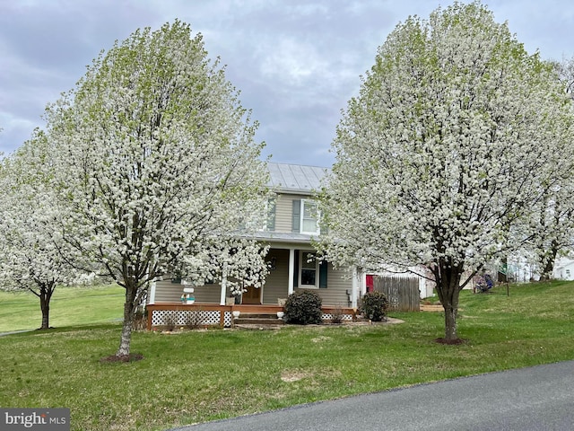 1671 Fravel Rd, Woodstock, VA 22664 - view of property hidden behind natural elements with covered porch, a front yard, metal roof, and a standing seam roof