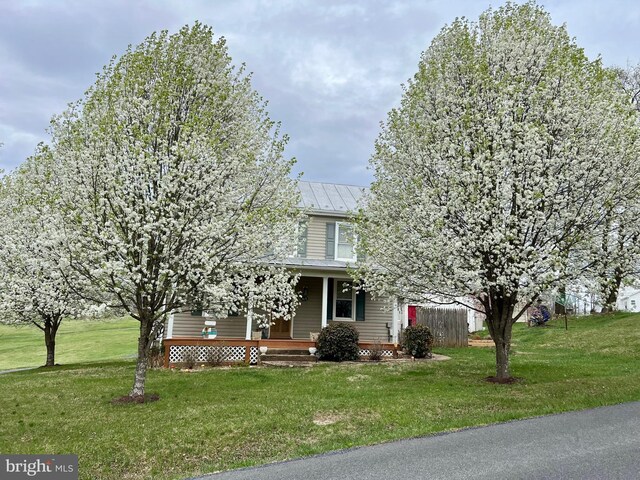 1671 Fravel Rd, Woodstock, VA 22664 - view of property hidden behind natural elements with covered porch, a front yard, metal roof, and a standing seam roof