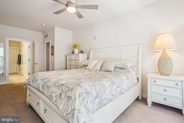 102 Saint Ives Pl Unit 209, National Harbor, MD 20745 - bedroom featuring visible vents, ensuite bathroom, light colored carpet, and a ceiling fan