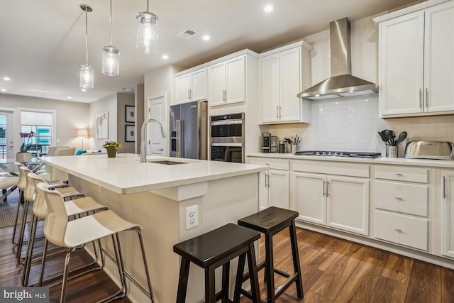 102 Saint Ives Pl Unit 209, National Harbor, MD 20745 - kitchen with visible vents, wall chimney exhaust hood, dark wood-style flooring, open floor plan, and appliances with stainless steel finishes