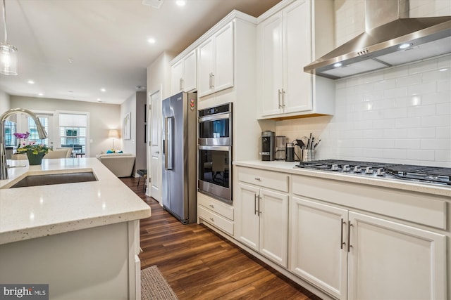 102 Saint Ives Pl Unit 209, National Harbor, MD 20745 - kitchen with wall chimney exhaust hood, dark wood-type flooring, white cabinets, a sink, and stainless steel appliances