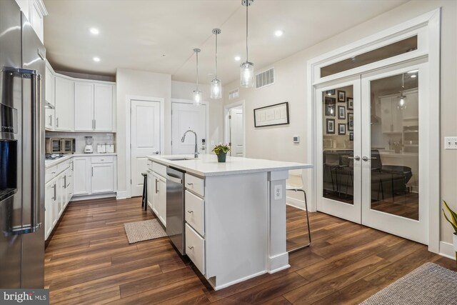 102 Saint Ives Pl Unit 209, National Harbor, MD 20745 - kitchen with white cabinetry, appliances with stainless steel finishes, light countertops, a sink, and french doors