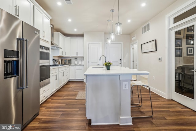 102 Saint Ives Pl Unit 209, National Harbor, MD 20745 - kitchen with visible vents, appliances with stainless steel finishes, dark wood-style flooring, light countertops, and a sink