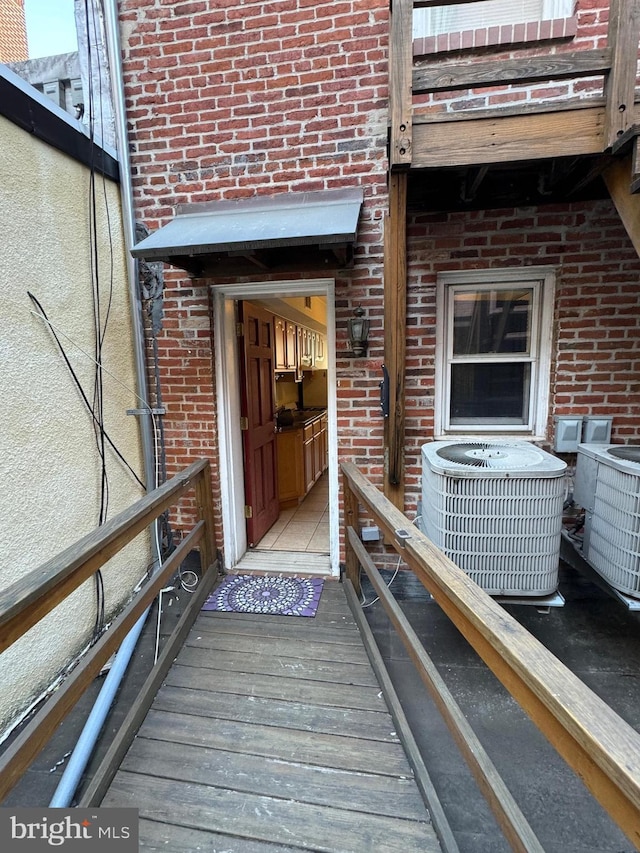 1637 Fleet St, Baltimore, MD 21231 - property entrance featuring brick siding and central air condition unit
